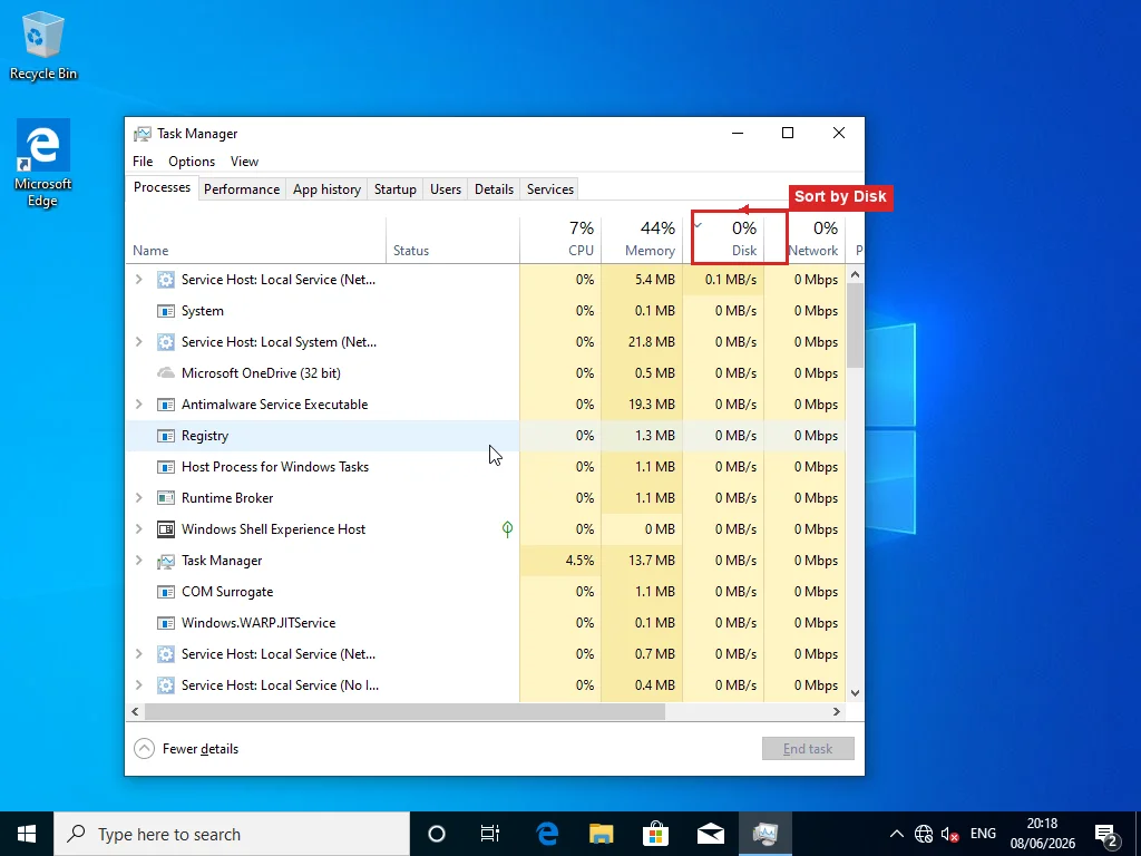 Task Manager Processes tab sorted by Disk column descending, with the Disk column header highlighted and active sort indicator